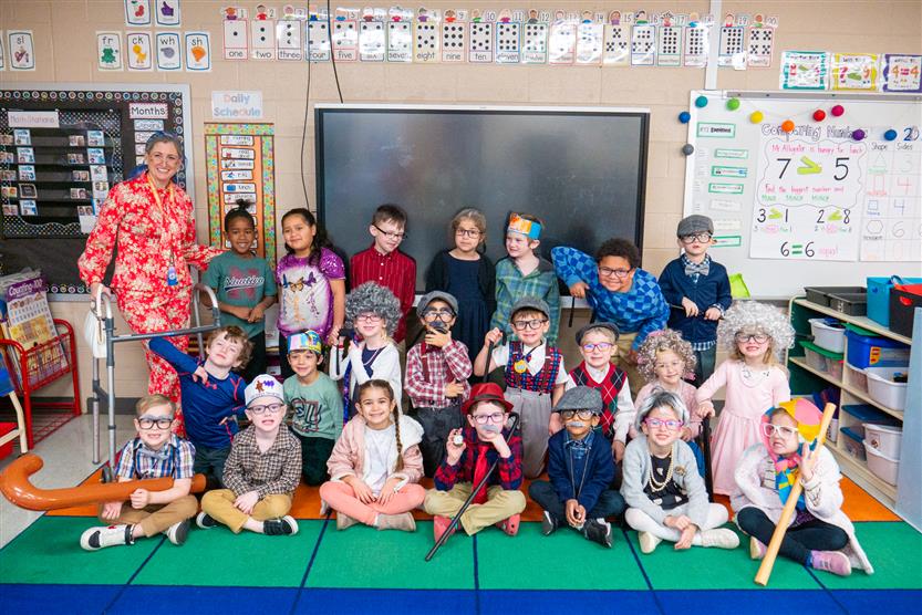 classroom of students and teacher dressed as 100 year olds